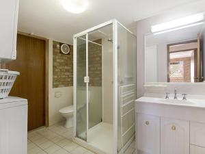 
a bathroom with a shower, toilet and sink at Tumut Unit 1 - Great unit in a central location to beaches, clubs and shopping in Coolangatta
