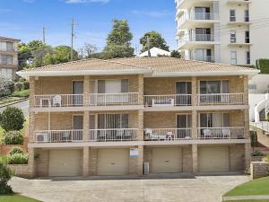 a brick apartment building with two balconies at Tumut Unit 1 in Coolangatta
