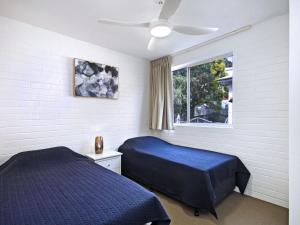 a bedroom with two beds and a window at White Caps Unit 3 in Gold Coast