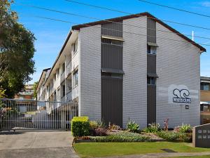 an apartment building with a sign that reads synergy at White Caps Unit 3 in Gold Coast
