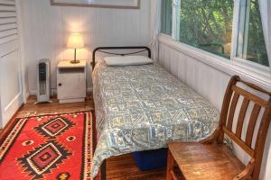 a small bedroom with a bed and a window at Finchley in Blackheath