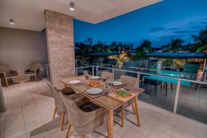 a dining table on the balcony of a house at Coconut Grove in Port Douglas