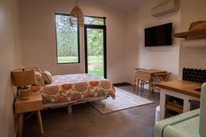 a bedroom with a bed and a table and a window at Studio on the Fairway Chewelah Golf Course in Chewelah