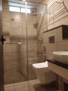 a bathroom with a shower and a toilet and a sink at Icon Residency in Chennai