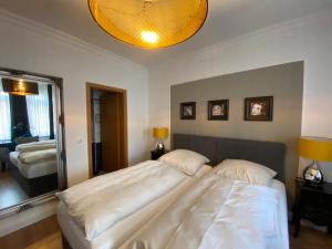 a bedroom with two beds and a large mirror at Hotel Hagspihl in Quakenbrück