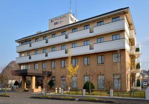 a building with a sign on top of it at Daini Prince Hotel Muroran View in Muroran