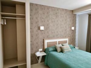 Postel nebo postele na pokoji v ubytování Hotel Los Conejos