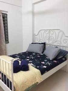 a white bed with blue pillows on top of it at Cinnamon Sutravilla Unit No D3A6 Lift Level 4, Sutravilla 2 in Kuantan