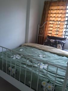 a bedroom with a bed with a bed frame and a window at Cinnamon Sutravilla Unit No D3A6 Lift Level 4, Sutravilla 2 in Kuantan