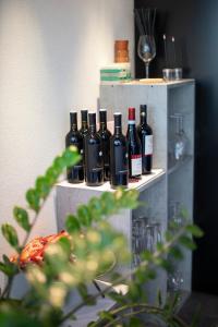 a group of wine bottles sitting on a shelf at Das Loft Hotel Willingen in Willingen