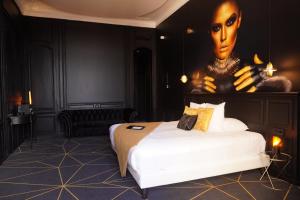 a woman is laying on a bed in a hotel room at Leprince Hotel Spa; Best Western Premier Collection in Le Mans