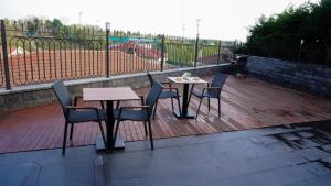 a patio with two tables and chairs on a deck at Selini Hotel İstanbul Airport in Istanbul