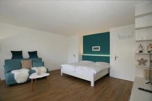 a bedroom with a bed and a table in it at Apartments Haus Quelle in Leukerbad