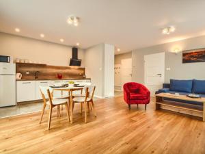 a living room with a table and chairs and a couch at Apartamenty Szarotka in Wisła