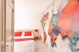 a bedroom with a map of the world on the wall at Hôtel Résidence Normandy Country Club by Popinns in Bellême