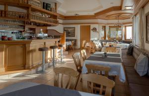 un restaurante con mesas y sillas en una habitación en Landhaus Alpenherz, en Aschau