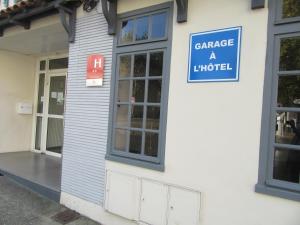 a sign on the side of a building at Contact Hotel de France in Saintes