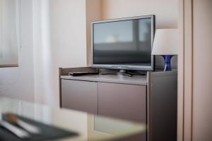 a flat screen tv sitting on top of a dresser at FIBES Apart Loft by Valcambre in Seville