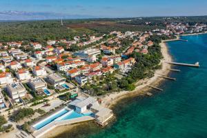 an aerial view of a resort near the water at Apartments Malic in Petrcane +17 photos