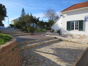 a set of stairs leading to a white house at casal do melro in Ericeira