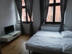 Posteľ alebo postele v izbe v ubytovaní Apartamenty przy Gimnazjalnej