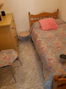 a bedroom with a bed and a table and a desk at Casa Montelouro in Muros +4 photos