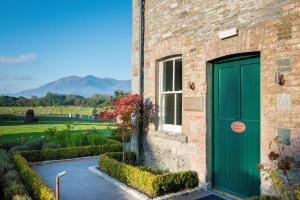 a blue door leading to a green garden at Cahernane House Hotel in Killarney