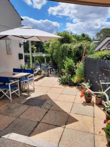 a patio with a table and an umbrella at The Labouring Man in Coldwaltham +5 photos