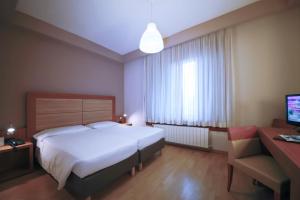 Postel nebo postele na pokoji v ubytování Monica Hotel Fiera