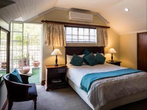 a bedroom with a large bed and a window at Gallo Manor Executive Bed & Breakfast in Johannesburg