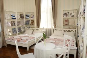 a bedroom with a bed and a table and chairs at Panska Poduszka in Lviv