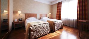 Postel nebo postele na pokoji v ubytování Monica Hotel Fiera