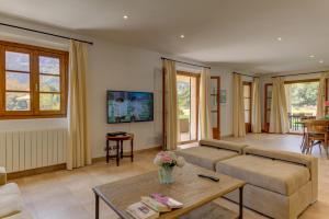 a living room with a couch and a table at Villa Vall Den March II in Pollença