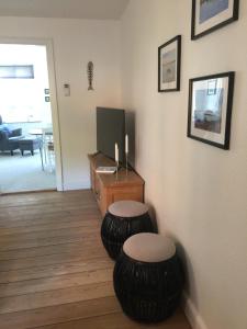 a living room with two stools and a television at Nakskov Overnatning in Nakskov