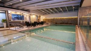 a large swimming pool in a building at Hosteria Santa Ana in Azogues