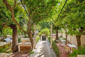 a walkway with trees and tables and benches at Heritage Villa Nobile in Dubrovnik