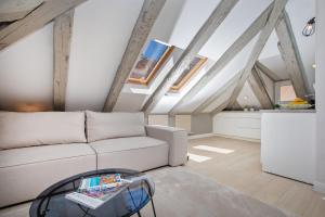 a living room with a white couch and a glass table at Heritage Villa Nobile in Dubrovnik