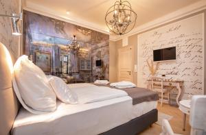 a bedroom with a large bed and a bathroom at Heritage Villa Nobile in Dubrovnik