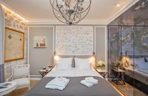a bedroom with a bed with towels on it at Heritage Villa Nobile in Dubrovnik