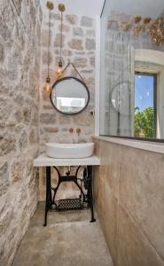 a bathroom with a sink and a mirror at Heritage Villa Nobile in Dubrovnik
