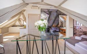 a room with a glass table with flowers on it at Heritage Villa Nobile in Dubrovnik