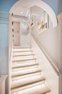 a staircase in a house with white walls and wooden floors at Heritage Villa Nobile in Dubrovnik