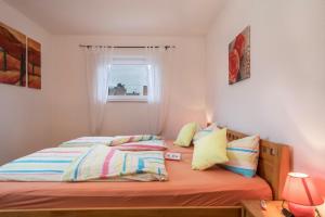een slaapkamer met een bed en een raam bij Ferienwohnung Steinhilber 2 in Eriskirch