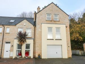 a brick house with two white garage doors at The Admiral in Coleraine