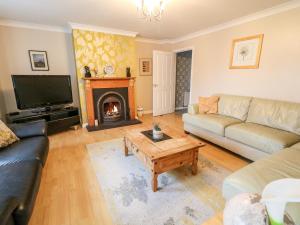 a living room with a couch and a fireplace at The Admiral in Coleraine