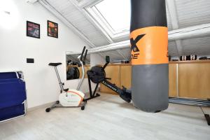 a room with a gym with exercise equipment in it at Bellagio Pescallo Guesthouse in Bellagio +13 photos