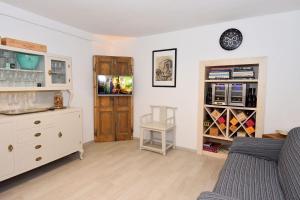 a living room with a couch and a dresser at Bellagio Pescallo Guesthouse in Bellagio