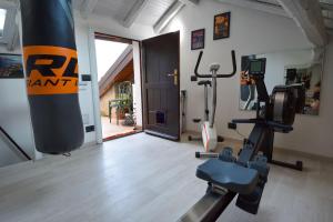 a gym with cardio equipment in a room at Bellagio Pescallo Guesthouse in Bellagio