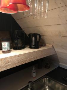 a kitchen counter with a sink and a counter top with a coffee maker at Stugan med Bryggan i Gamla Staden in Eskilstuna