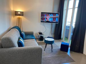 a living room with a couch and a flat screen tv at Douillet BY DREAM APARTMENTS in Serris